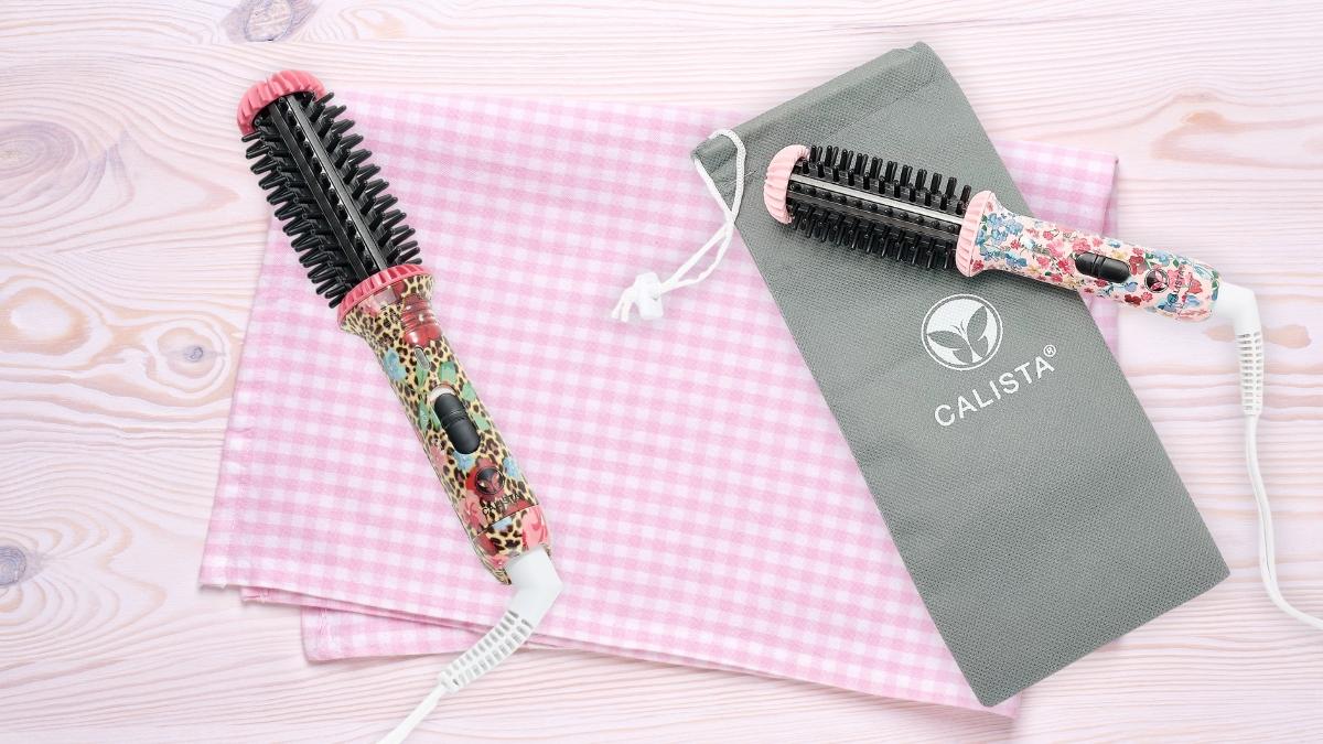 Colorful Calista GoGo Mini 2.0 Round Brush styling tools shown with travel pouch on a pink checkered cloth.